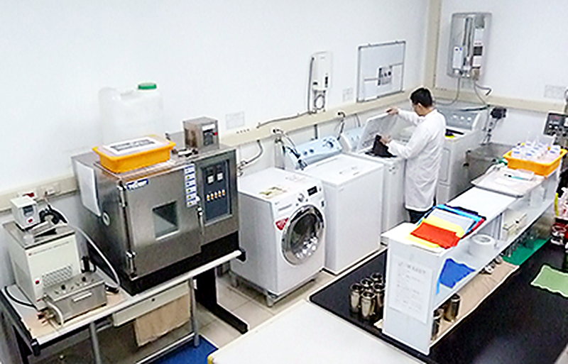 Textile testing laboratory running wash, shrinkage and colour-fastness checks