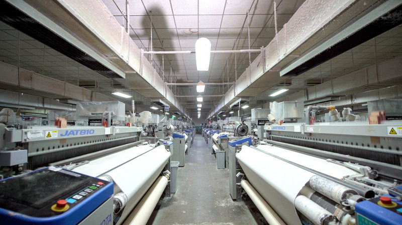 Fabric production line running woven fabric before cutting